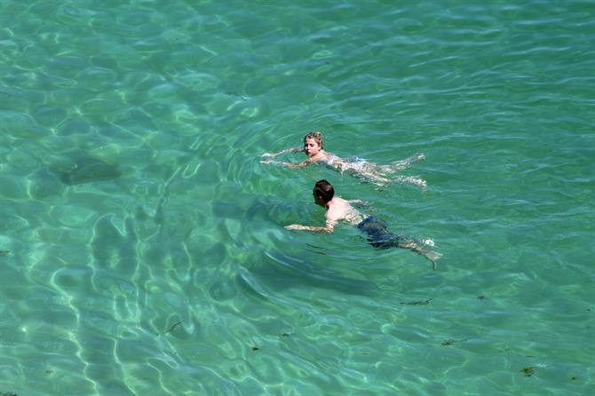 People bathing in the clear waters on the Cíes Islands