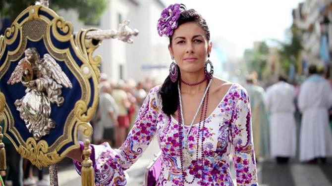 Mujer vestida de flamenca en la procesión 