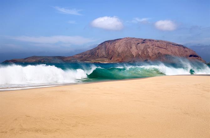 Huge waves breaking at Playa de Las Conchas in Lanzarote